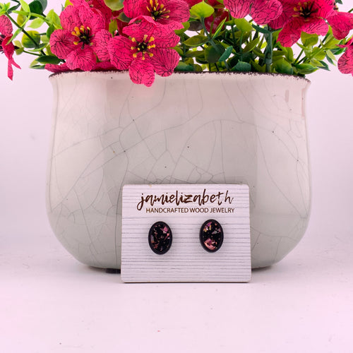 Pink flecks against a black background, oval stud earrings with Black wood frames by Jamielizabeth