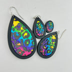 Wild Side rainbow leopard earrings shown in black wood in four sizes