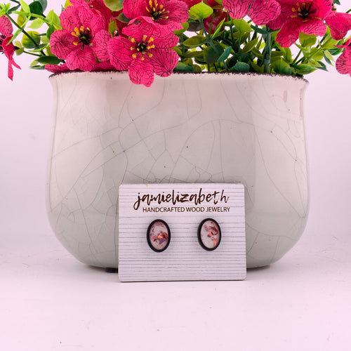Pink flecks against a white background, oval stud earrings with Walnut wood frames by Jamielizabeth
