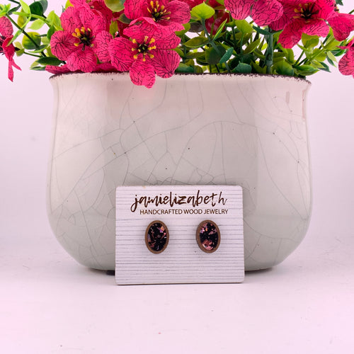 Pink flecks against a black background, oval stud earrings with Walnut wood frames by Jamielizabeth