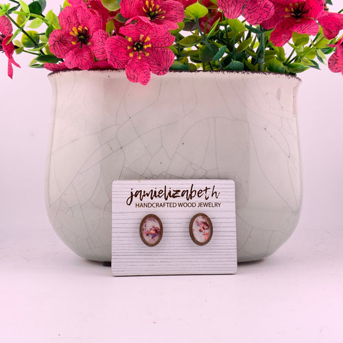Pink flecks against a white background, oval stud earrings with Black wood frames by Jamielizabeth