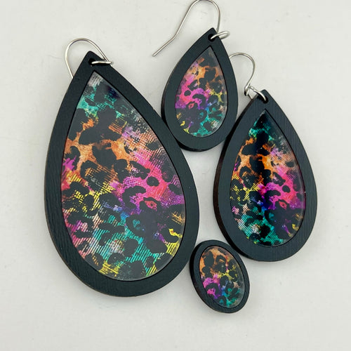 Neon After Dark Earrings shown in black wood