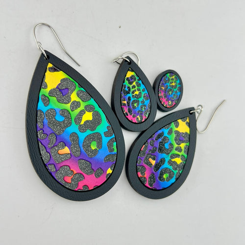 Wild Side rainbow leopard earrings shown in black wood in four sizes